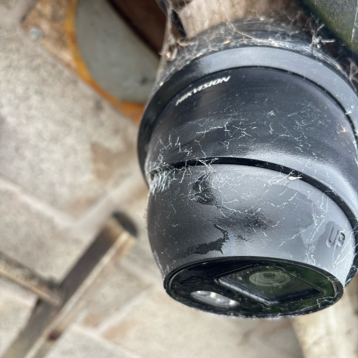 Old Hikvision dome CCTV camera covered in cobwebs, in need of a clean and repair